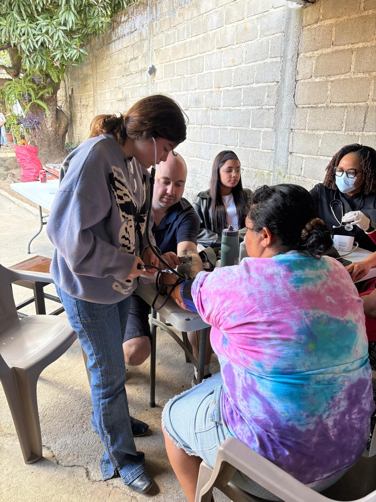 Celeste taking a patient's blood pressure
